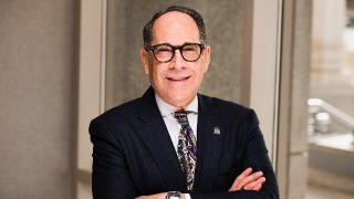 Image of Brian B. Shulman, Dean of School of Health and Medical Sciences, crossing his arms and smiling 