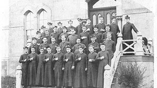 c. 1872. Faculty and seminarians on rear steps of seminary building.
Second row, third from right, Reverend James Corrigan, director of the seminary. – AAN