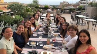 Students enjoy their final dinner on a Roman roof with Dr. Romani, Program Director.