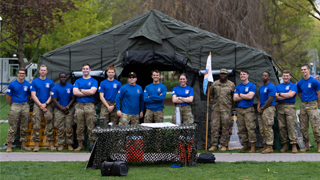 Image of ROTC members during Pirate Week 2023 in front of a tent. 
