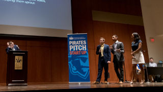 Speakers discussing on stage at the Pirates Pitch convention
