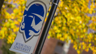 Seton Hall Pirate logo banner with orange leaves in the background