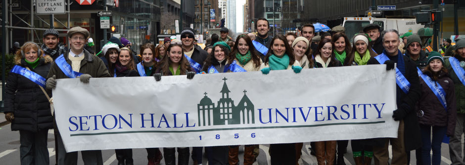 Members of the Seton Hall community in the streets of New York City holding up a banner at the St. Patrick's Day Parade.