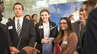 Students talking with an employer at a career fair