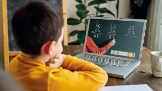 Child learning mathematics on a laptop. 