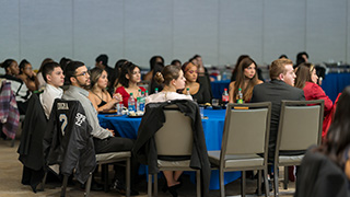 a picture of students sitting down in an event