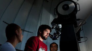 students looking into telescope at SHU Observatory