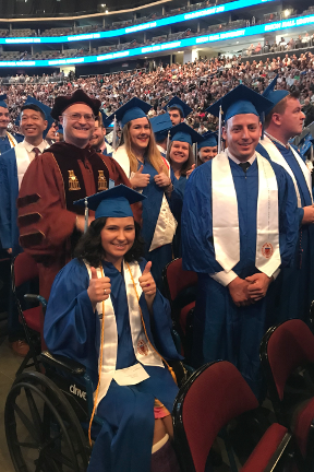 Student in a wheelchair at graduation ceremony. 
