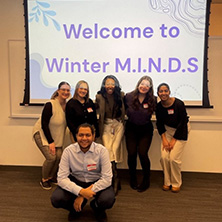 a group of students from the Winter M.I.N.D.S program in front of a screen that says "Welcome to Winter M.I.N.D.S"